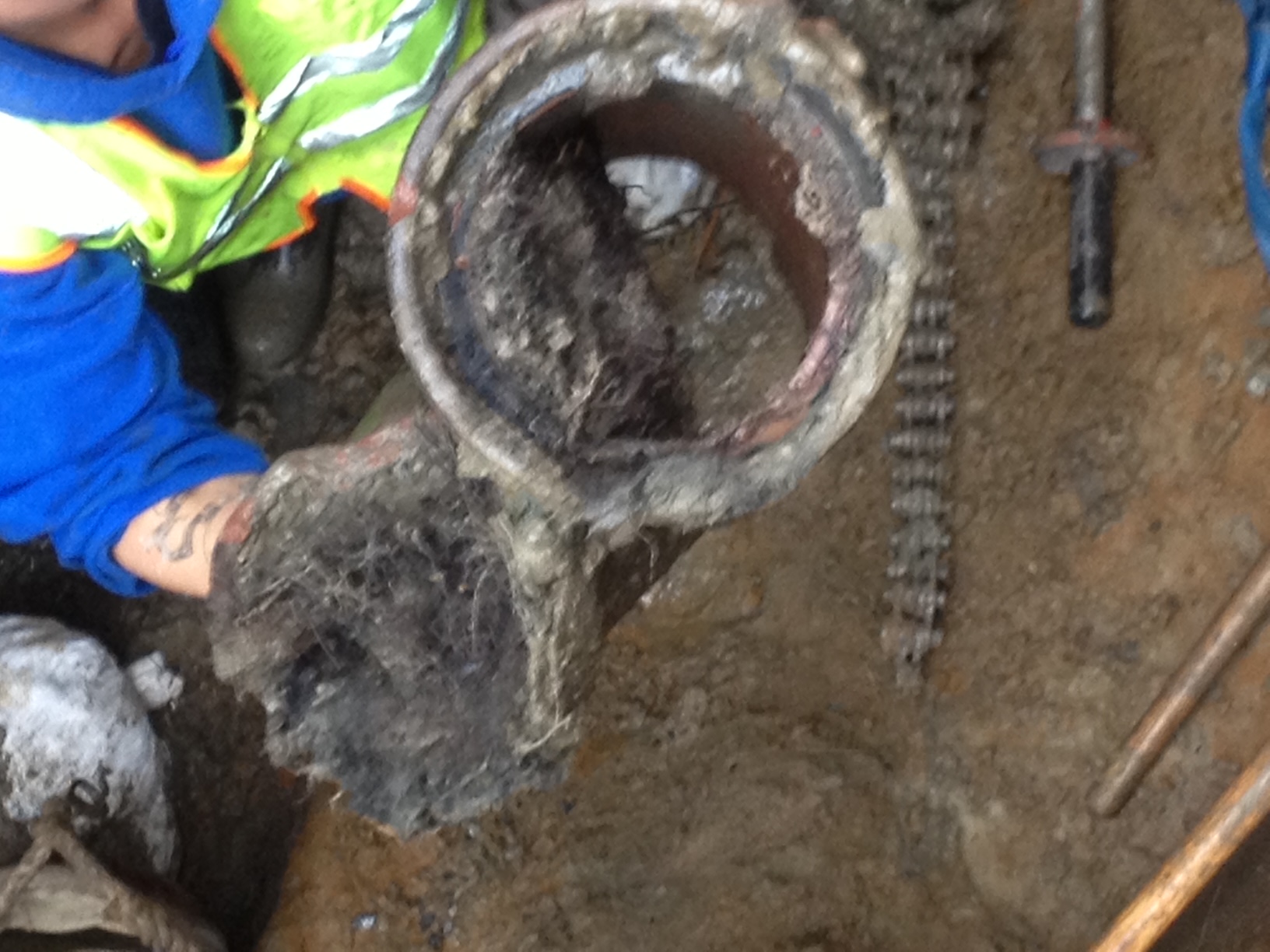 Rush Plumbing worker displaying problem with water main in Seattle Metro Area