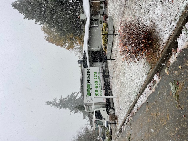 Rush Plumbing truck in the snow where they are working on frozen pipe prevention