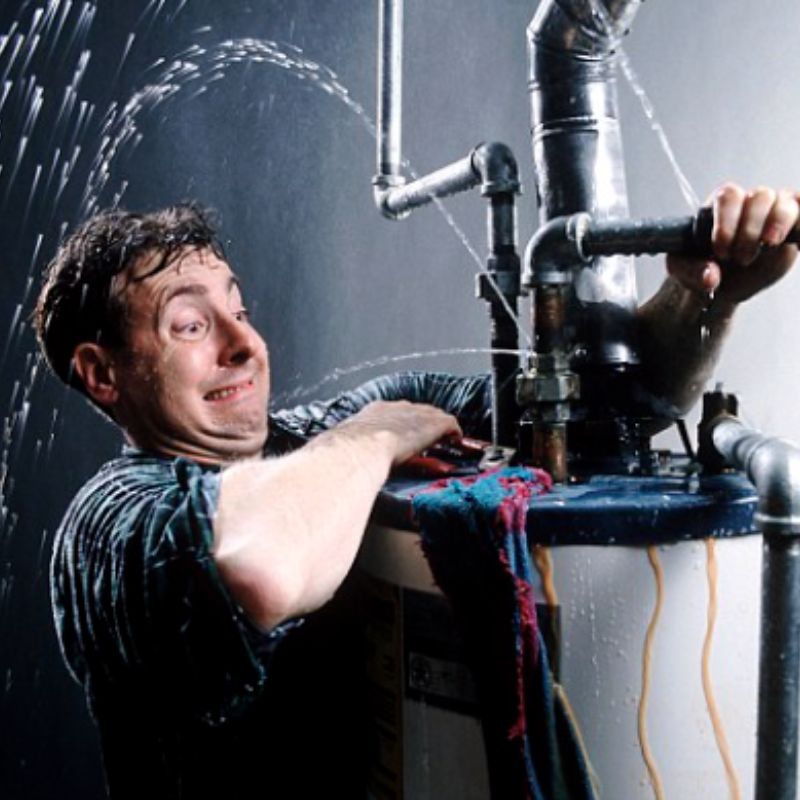 man struggling with a leaking waterheater who is wishing he hired Rush Plumbing for Plumbing Leak Detection Services Water Leak Detection
